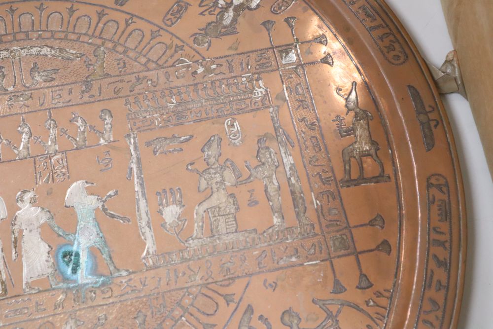 A large circular copper tray with white metal inlay depicting ancient Egyptian scenes, diameter 61cm